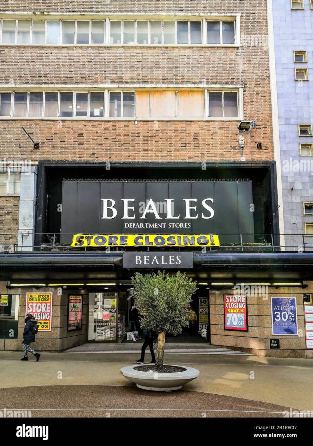 Beales Bournemouth Department Store Exterior Shoppers walk past a Beales department store with a closing-down sale sign in the window