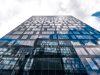 HSBC Pays €294M to Settle Belgian Tax Case HSBC bank building exterior with a sign showing the company logo in Geneva, Switzerland.