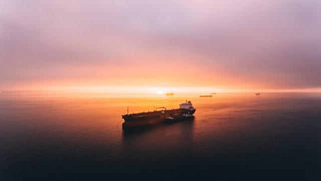 Iranian Parliament Votes to Close Strait of Hormuz After U.S. Attacks Aerial view of oil tankers navigating the narrow Strait of Hormuz under clear skies